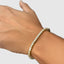 Close-up detail of 3mm diamond tennis bracelet in yellow gold