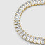 Close-up sparkle detail, baguette stones catching light in gold setting
