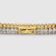 Yellow gold baguette tennis bracelet stacked with other pieces, layered shot
