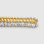 Yellow gold baguette tennis bracelet, unisex styling on wrist
