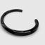 Close up DVNCI black twisted cuff bangle twist detail reinforced steel luxury