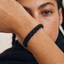 DVNCI black basket weave cuff bangle overhead studio shot luxury stealth jewelry
