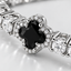 Close up DVNCI four leaf clover charm detail diamond simulant white gold luxury jewelry
