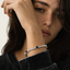 Close up DVNCI diamond simulant tennis bracelet stone setting detail white gold
