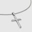 Close up DVNCI white gold fluted cross pendant necklace worn on model neck detail