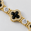 DVNCI yellow gold four leaf clover bracelet overhead studio shot white background luxury
