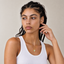 DVNCI Hamsa evil eye pendant necklace worn by model lifestyle shot gold jewelry
