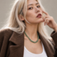 Close up DVNCI jade natural stone necklace worn on model neck detail shot luxury

