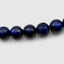 DVNCI lapis lazuli natural stone necklace coiled overhead studio shot white background
