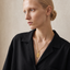 DVNCI Leo zodiac pendant necklace worn by model lifestyle shot gold jewelry
