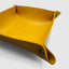 Close up DVNCI mustard yellow vegan leather tray folded corner stud detail