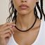Gold lobster clasp detail on natural black onyx bead necklace

