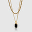Close up DVNCI black onyx pendant layered chain necklace worn on model neck detail shot