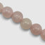 Close up DVNCI natural pink quartz stone necklace texture detail spiritual jewelry
