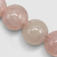 DVNCI pink quartz natural stone necklace coiled overhead studio shot white background
