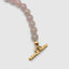 Close up DVNCI pink quartz natural stone necklace worn on model neck detail shot
