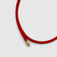 Close up DVNCI 18k gold tip on 2.7mm red woven silk cord magnetic bracelet
