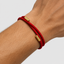 DVNCI red silk cord bracelet layered with gold chain bracelet red and gold wrist stack
