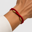 DVNCI unisex red magnetic bracelet worn on man's wrist with watch lifestyle shot
