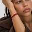 DVNCI red string bracelet single loop worn on wrist minimalist everyday styling
