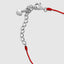 Close up DVNCI red string clover bracelet worn on model wrist detail shot moissanite