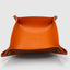 DVNCI saffron orange vegan leather jewelry tray styled with rings necklaces earrings