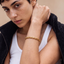 DVNCI gold wheat chain bracelet overhead studio shot luxury minimalist jewelry