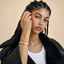 DVNCI white gold twisted cuff bangle overhead studio shot luxury sculptural jewelry
