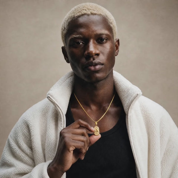 Kai is wearing our stunning DVNCI Aquarius birthstone Zodiac Star sign pendant in gold