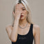 Eva wearing a white gold Cuban chain necklace with Milgrain detailing