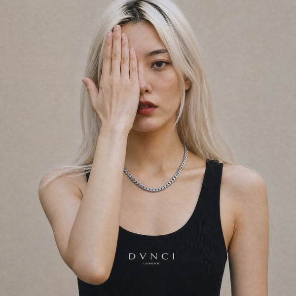 Eva wearing a white gold Cuban chain necklace with Milgrain detailing